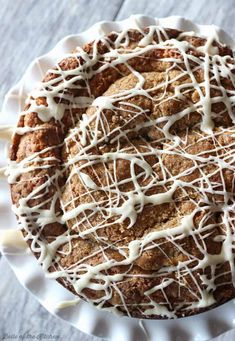 a cake covered in white icing and drizzled