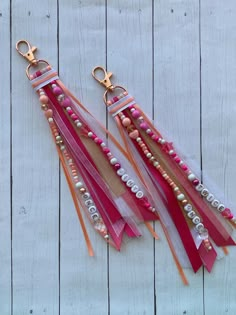 pink and orange tassels with beads hanging from hooks