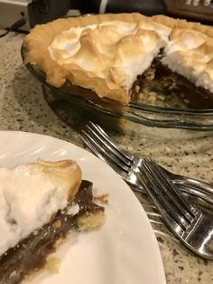 a slice of pie sitting on top of a white plate next to a silver fork