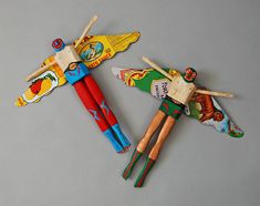 two wooden toy dragon wands on a gray surface