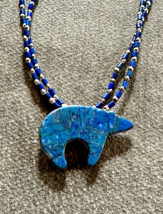 Pittsburgh artist Carolyn Roberts combines color, shape and texture in one-of-a-kind jewelry designs that are strikingly beautiful. "Bear" necklace of lapis lazuli set in sterling silver with lapis and silver beads measures 22" long. Blue Sterling Silver Necklace With Inlay, Artisan Blue Inlay Necklaces, Unique Blue Necklace With Inlay, Artisan Blue Lapis Lazuli Jewelry, Bear Necklace, Jewelry Designs, Silver Beads, Lapis Lazuli, Pittsburgh