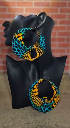 These fabric hoop earrings are lightweight and feature vibrant colors that will compliment your fashion aesthetic. Fabric Hoop Earrings, Africa Jewelry, African Print Shirt, Unique Earring, African Crafts, Mixed Media Jewelry, Abstract Earrings, African Earrings, Hoop Earrings Style