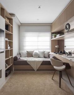 a room with a bed, desk and shelves filled with bookshelves in it