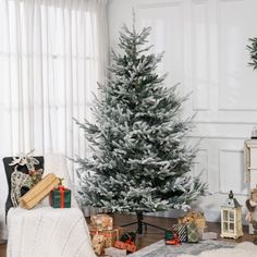 a living room with a christmas tree and presents on the floor