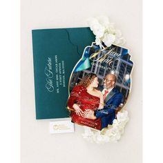 a wedding photo is displayed on the back of an ornament next to a card