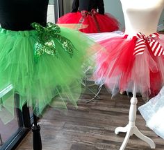 two tutu skirts with green and red bows on them