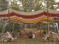 several tents set up in the middle of a forest