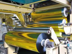 rolls of colored paper being made in a factory