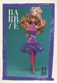 the barbie doll is wearing a purple dress and holding a pink hairdow in her hand