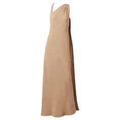 Chado Ralph Rucci, Couture, beige, silk crepe, bias cut gown having a bias cut back panel that drapes from the shoulder to the floor on one side and a neckline that has gentle pleating at one shoulder and a geometric triangle shape at the opposite shoulder. Evening Gown With Asymmetrical Neckline And Bias Cut, Elegant Beige Sleeveless Asymmetrical Dress, Silk Evening Dress With Asymmetrical Neckline And Bias Cut, Silk Gown With Bias Cut And Asymmetrical Neckline, Formal Silk Crepe Bias-cut Dress, Elegant Asymmetrical Bias Cut Maxi Dress, Formal Silk Crepe Bias Cut Dress, Formal Bias Cut Silk Crepe Dress, Elegant Asymmetrical Beige Maxi Dress