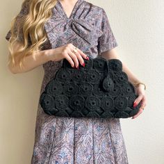 Consider this vintage clutch photo-ready! Black silk lining peeks through the black crochet. Original metal zipper at the top of the clutch with a black crochet charm attached. Two pockets in the interior. Please note: there are some teeth missing on the zipper, but the zipper is still functional. Please check photos provided. Heavy weight. No label. No stretch. Fabric content is silk. Clutch is in great condition.   Measurements Length: 10 inches Width: 9 up to 16 inches Depth: 4 inches Black Crochet Bag For Party, Elegant Black Crochet Bag For Evening, Black Crochet Clutch Bag For Evening, Crochet Clutch Evening Bag, Chic Black Crochet Bag For Party, Black Crochet Clutch For Evening, Chic Crochet Bag For Evening, Evening Crochet Clutch, Silk Clutch