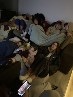 a group of people laying on top of a bed