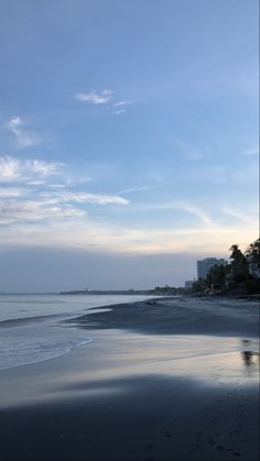 the sky is reflected in the wet sand