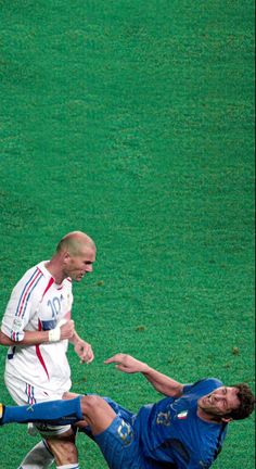 two men are playing soccer on the field