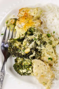 a white plate topped with chicken and broccoli covered in cheese next to rice