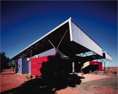 a red and white building with a metal roof