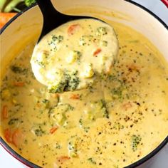 broccoli and cheese soup in a pot with a ladle scooping it