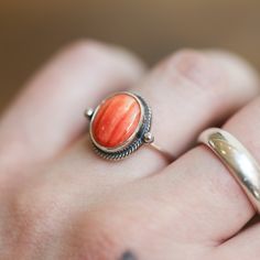 Sometimes you want to gaze down at your ring and see perfect balance and grace. That's what the Delica Dainty Ring has to offer. High-grade Spiny Oyster Shell Ring with a simple, sterling silver design. Perfect little ring. Lovely, traditional, dainty ring of 10X12 mm Spiny Oyster cabochon set in .925 sterling silver - oxidized and burnished bezel and wire. Simple, elegant and perfect. This lovely little orange-red ring is created using traditional silversmithing techniques in my Baltimore, MD s Untreated Round Band Jewelry As Gift, Untreated Round Band Jewelry Gift, Heirloom Oval Stackable Jewelry, Untreated Oval Ring Fine Jewelry, Untreated Oval Rings Fine Jewelry, Untreated Oval Ring In Fine Jewelry Style, Oval Spiritual Ring With Polished Finish, Oval Spiritual Rings With Polished Finish, Unique Oval Stackable Jewelry