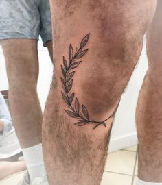 a man's leg with a small tattoo on the lower part of his leg