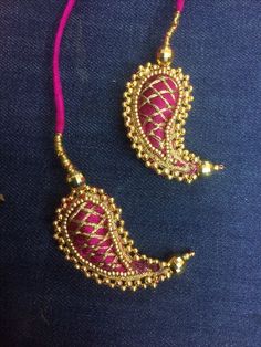 two necklaces with gold beads and pink thread