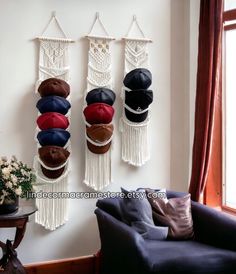 several hats are hanging on the wall next to a chair