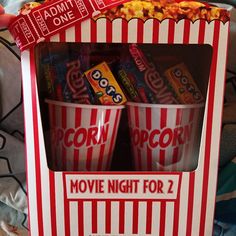 the popcorn movie night for 2 is in a red and white striped box with candy