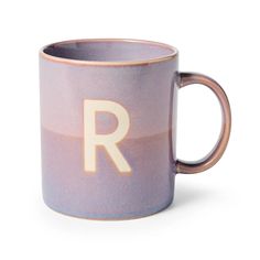 a purple coffee mug with the letter r on it's front and bottom half