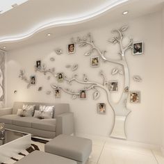 a living room with pictures on the wall and a tree in the center, as well as couches