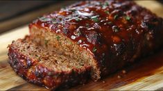 meatloaf with sauce and herbs on a cutting board