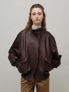 This Standard Collar Leather Blouson exudes a vintage charm with its subtle sheen and scratch texture. The oversized silhouette and stand collar design give off a neutral and casual vibe. - Made of 100% cow leather for durability and elegance- Lined with a blend of polyester and Bemberg for comfort- Ribbed cuffs and hem for a comfortable fit Collared Leather Outerwear, Fitted Brown Leather Jacket With Collar, Classic Vintage Brown Leather Outerwear, Leather Jacket Fur Collar, Brown Single-breasted Collared Leather Jacket, Collar Designs, Oversized Silhouette, Leather Collar, Vintage Brown