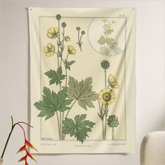 a wall hanging with flowers and plants on it