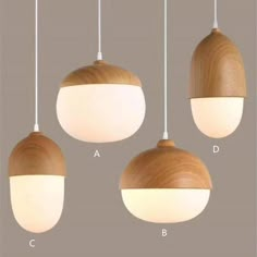 three different types of lights hanging from the ceiling and one is white with wood on it