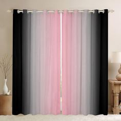 a pink and black curtain hanging in front of a window