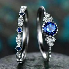 two silver rings with blue and white stones