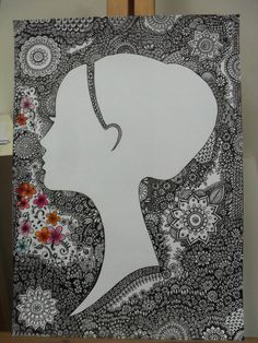 a drawing of a woman's head in black and white with flowers on it