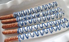 six blue and white pretzels in a tray