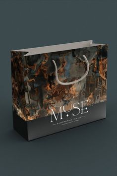 a shopping bag with the word muse printed on it's front and side handles