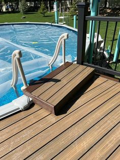 an above ground swimming pool with steps leading up to the deck and inflatable safety rails