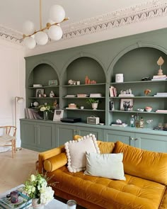 a living room filled with lots of furniture and bookshelves on top of shelves