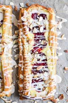 two desserts with fruit and nuts on top of each other, one is covered in icing