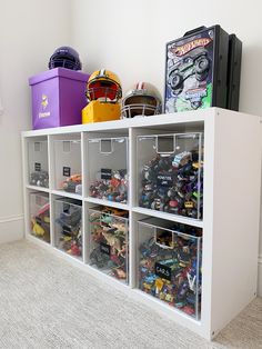 a shelf filled with lots of toys and bins on top of it's sides