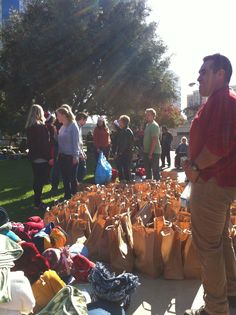 a group of people standing around bags on the ground