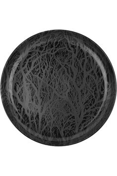 an oval black plate with intricate designs on it