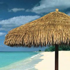 an umbrella made out of straw on the beach