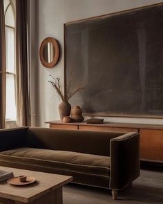 a living room filled with furniture and a chalkboard