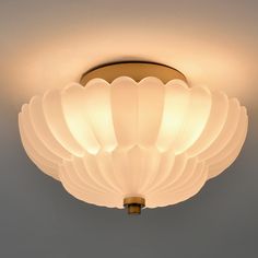 a close up of a light fixture on a ceiling in a room with gray walls