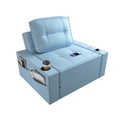 a blue couch that is sitting in the middle of some sort of bed with an electronic device on it