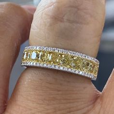 a woman's hand with a yellow and white diamond ring