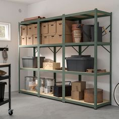 a room filled with lots of boxes and containers on top of shelves next to a bike