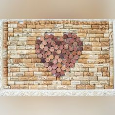 a cork board with a heart made out of wine corks